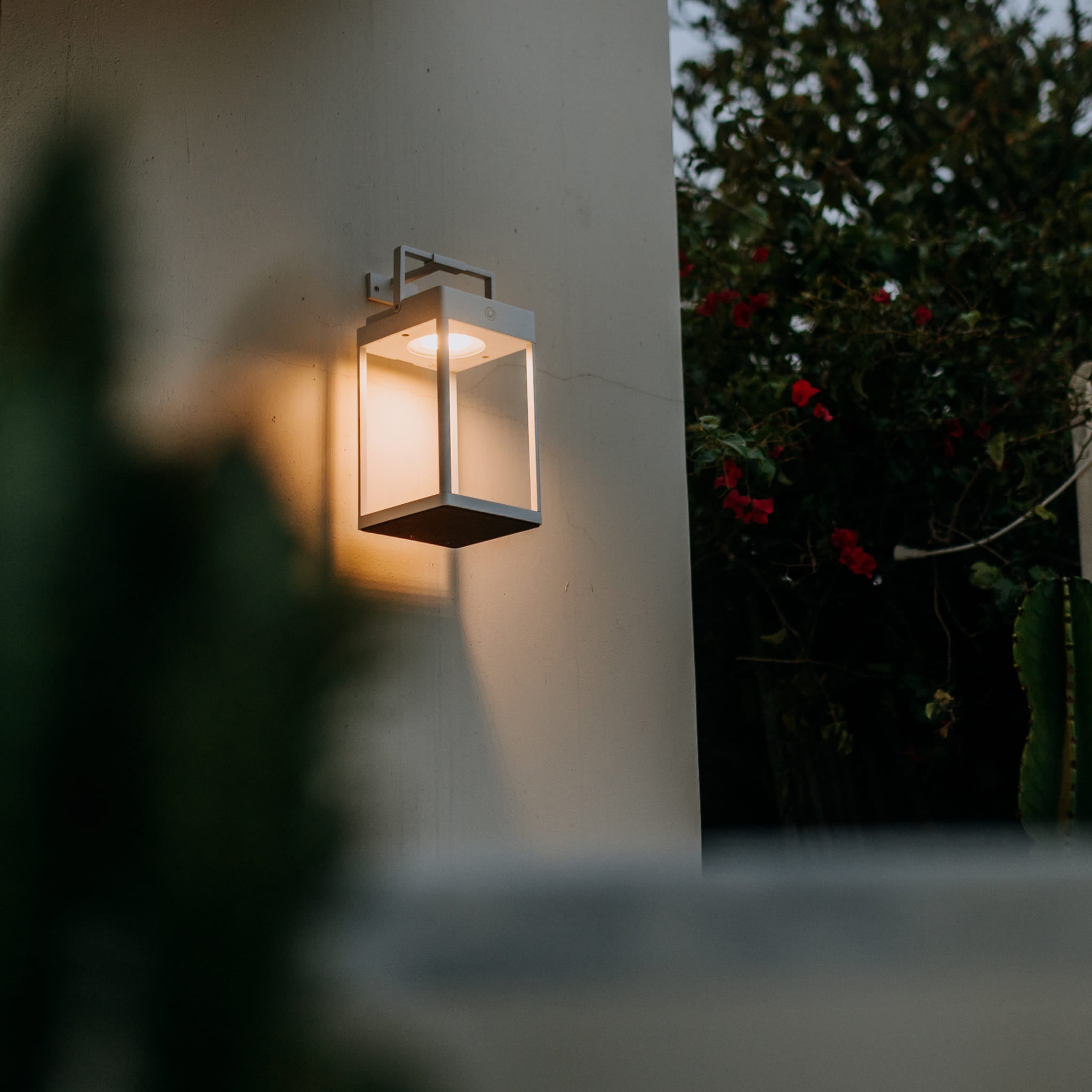 Solar lantern at dusk on wall with wall mount bracket