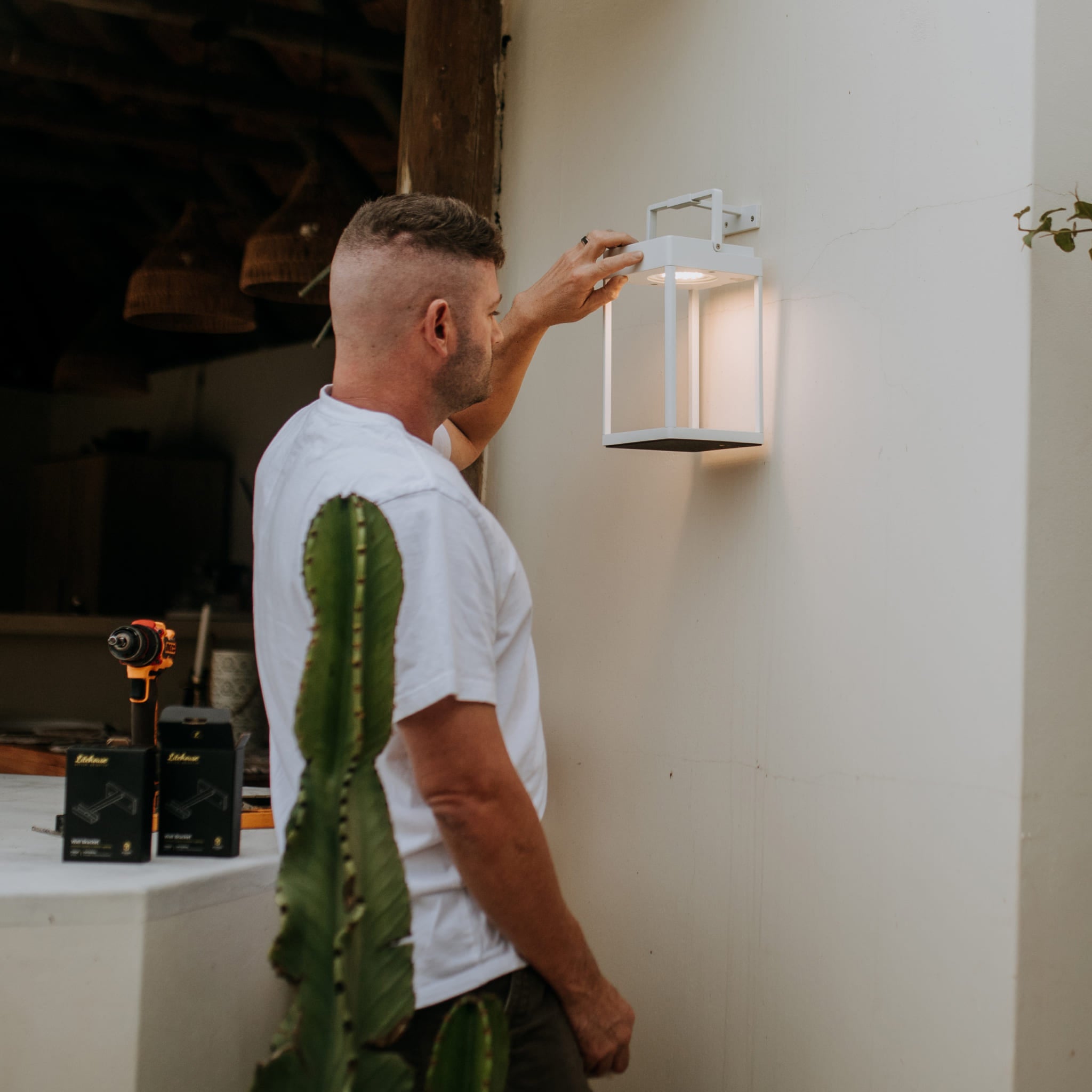 Installing the Litehouse Solar Lantern Wall Bracket onto a wall in white