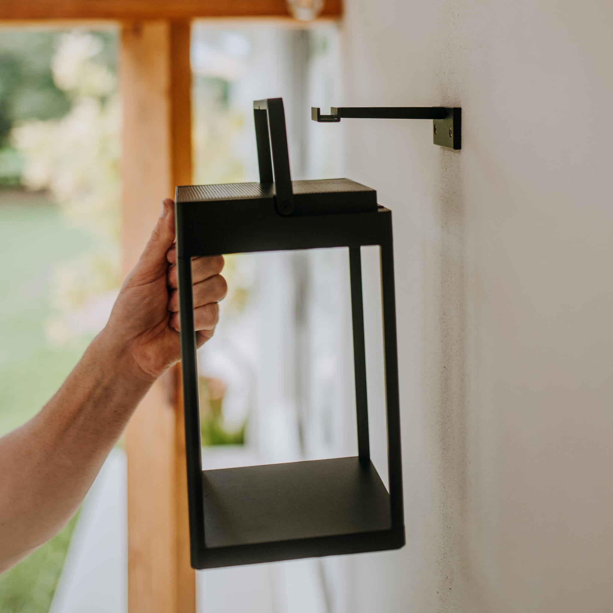 Placing a Solar Lantern onto a Wall Bracket