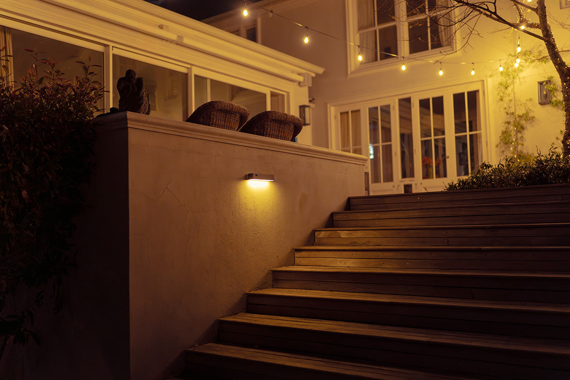 Litehouse Solar Wall Light lighting up a staircase and entryway as motion is detected